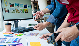 Two people comparing images to use for a digital ad