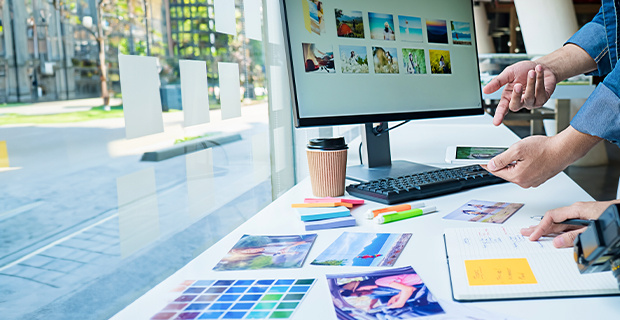 Two people comparing images to use for a digital ad